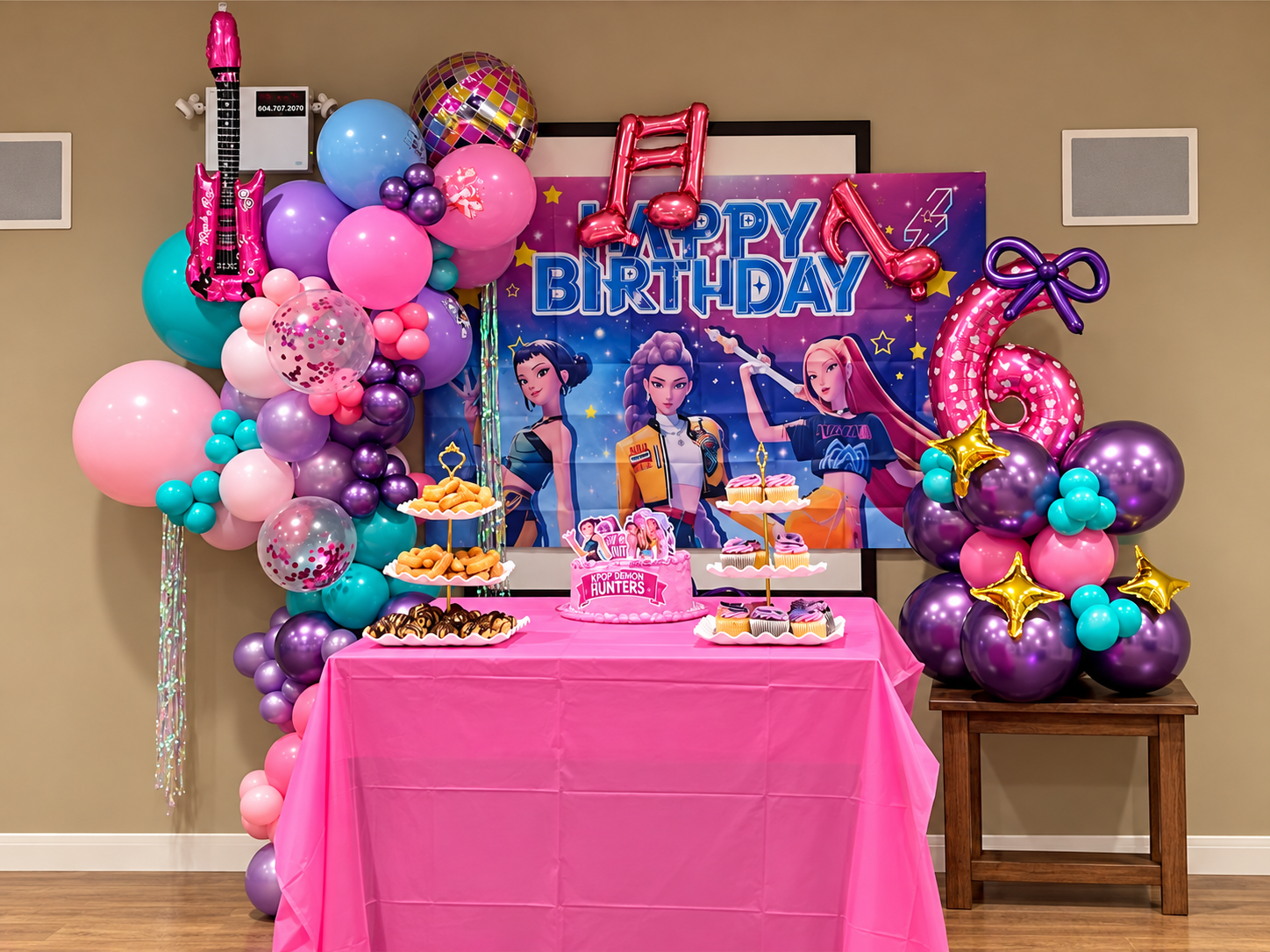Colorful musical-themed balloon decoration for a sixth birthday